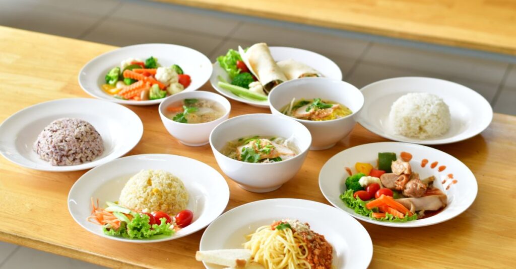 A variety of Asian and Italian dishes presented beautifully on a wooden table, showcasing diverse flavors.