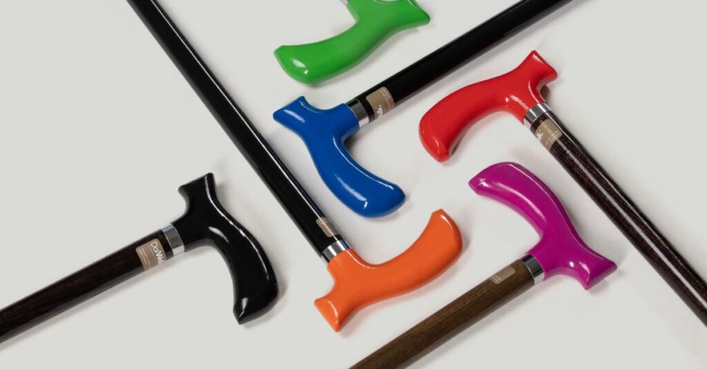 A collection of vibrant, ergonomic walking canes in various colors and modern designs.