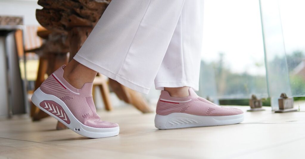 Fashionable pink sneakers paired with white pants, perfect for casual indoor settings.