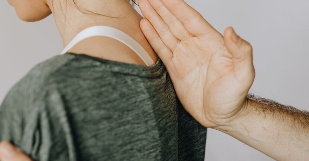Side view of crop unrecognizable orthopedist in wristwatch examining anonymous woman in casual clothes in doctor office in hospital