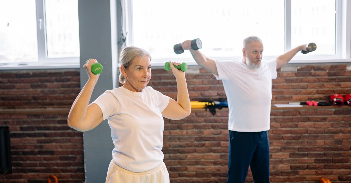 Elderly man and woman workout with dumbbells promoting healthy lifestyle and fitness.