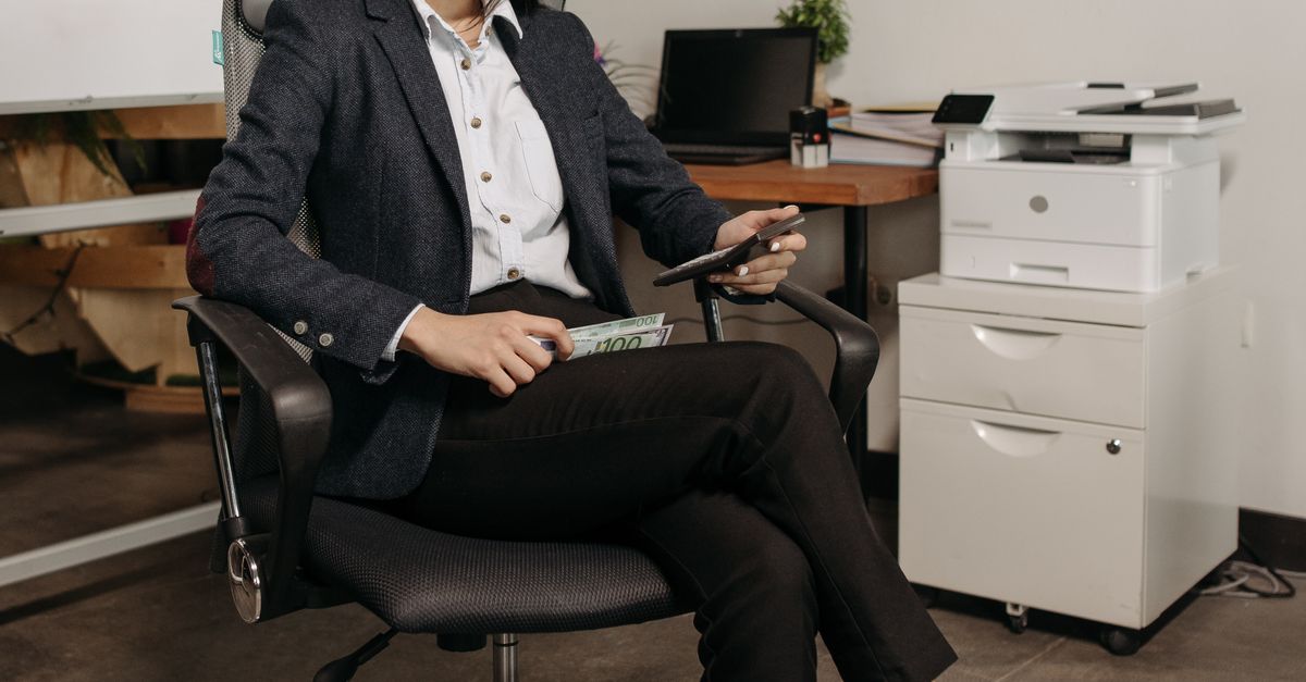 Professional woman sitting confidently in an office chair, showcasing modern work environment.