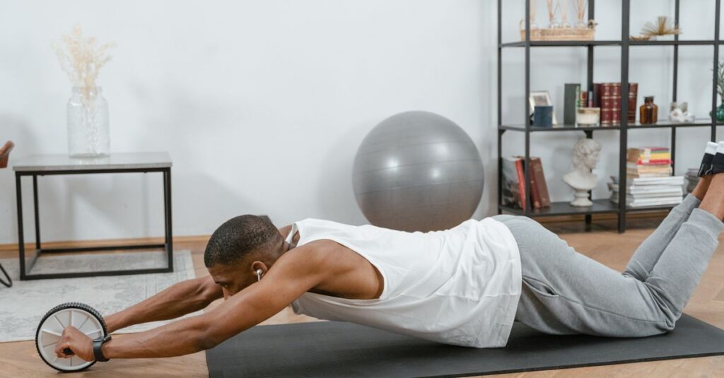 Man using an ab roller on a yoga mat indoors, promoting fitness and healthy lifestyle.