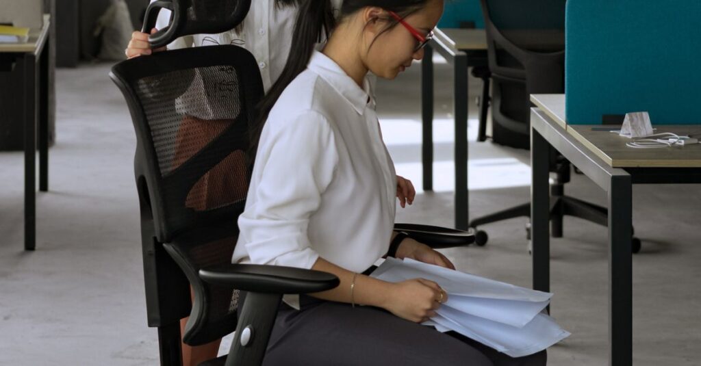 Businesswomen in a modern office reviewing documents, focusing on work processes.