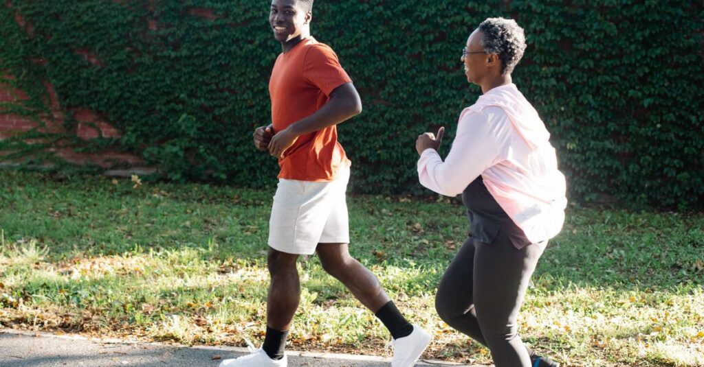 African American couple jogging outdoors on a sunny day promoting an active lifestyle.